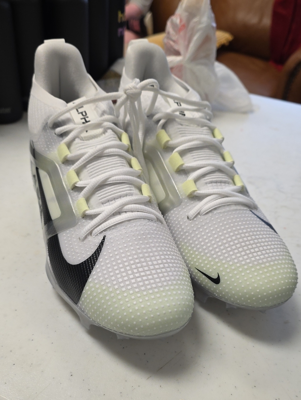 Nike Men's White Alpha Menace 4 Cleats with Black Swoosh and Pale Yellow Accents